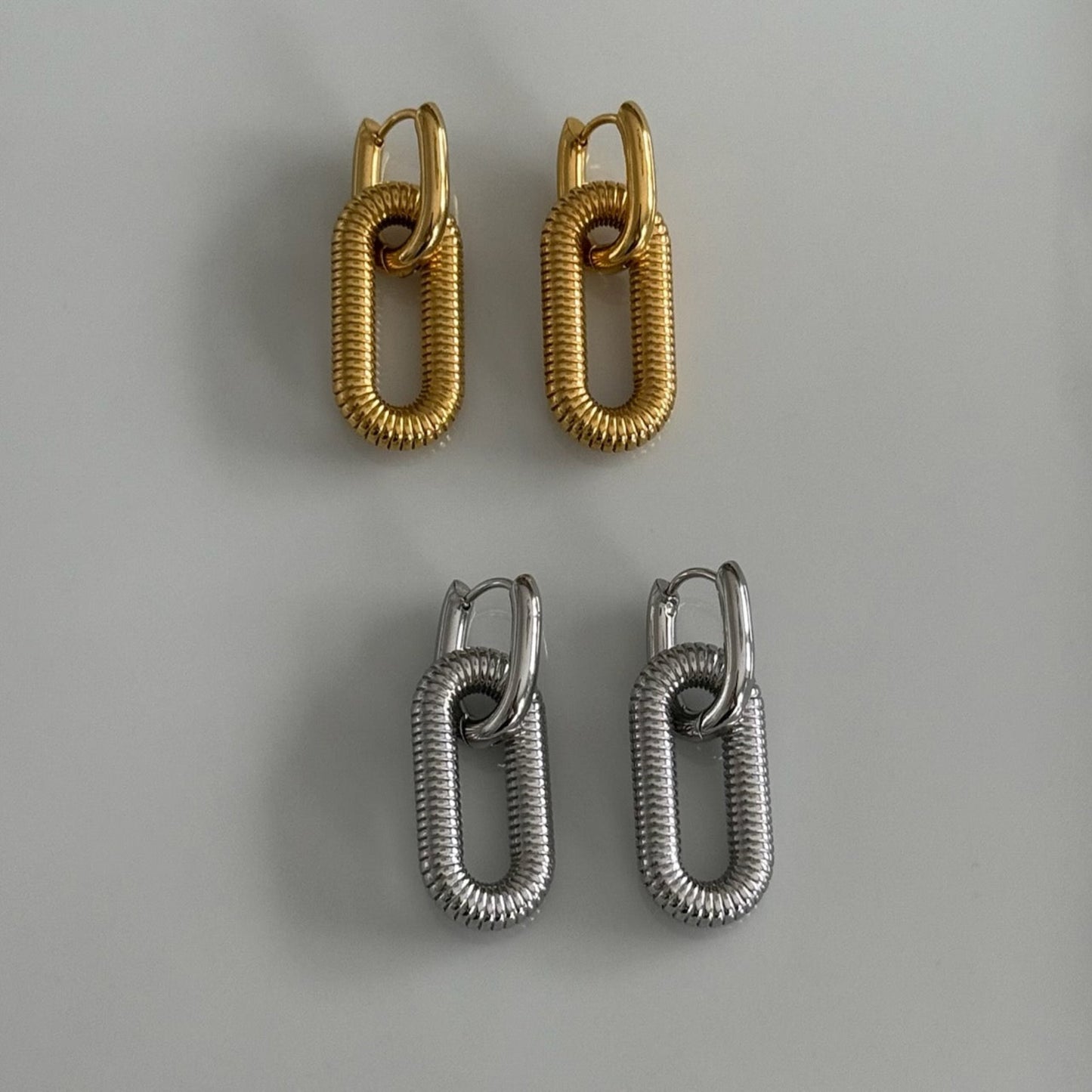 Two in one Pair of earrings in gold and silver made of stainess steel material. Link Hoops