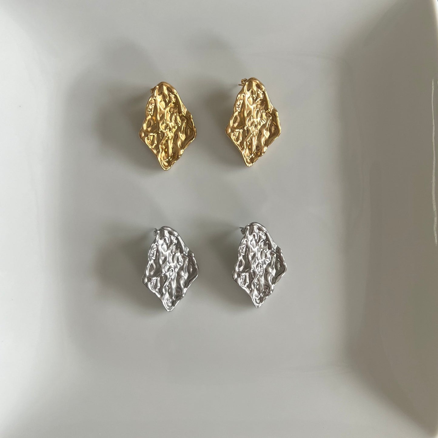 Irregular textured gold and silver earrings