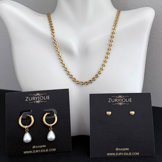 Gold necklace and earrings on a mannequin with ZuryJolie branding.