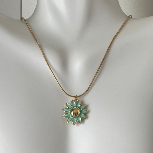 Necklace with a turquoise flower pendant on a mannequin.